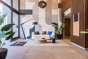 A modern interior with a sofa, coffee table, and potted plants.