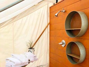 A tent with a wooden wall, a metal faucet, and two metal rings. - Pet-Friendly and Gorgeous Safari Tent for a Glamping Getaway near White River National Forest, Colorado (Carbondale)