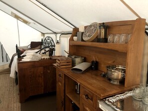 A compact kitchen with wooden cabinetry, a sink, and various kitchen utensils. - Glamping Tent Rental for Farm Stay at a Working Ranch in Carbondale near Aspen and Maroon Bells, Colorado (Carbondale)