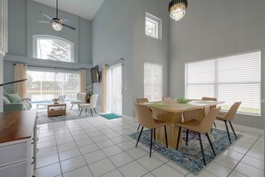 A spacious living area with a dining table, chairs, and a ceiling fan. - Kissimmee Family Fun w/ Private Pool & Pond Views! (Kissimmee)