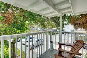 A covered porch with a view of parked cars and a street. - Walk to Beach! Atlantic Beach Extended Stay (Atlantic Beach)