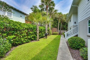 A well-maintained residential lawn with a pathway leading to a wooden deck. - Walk to Beach! Atlantic Beach Extended Stay (Atlantic Beach)
