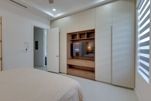 A bedroom with a bed, a wardrobe, a TV, and a window with blinds. - 4 Mi to Dtwn Mcallen, Sleek Couples Condo! (McAllen)