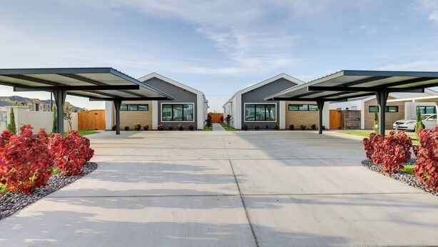 A modern residential area with two houses connected by a driveway, surrounded by landscaped gardens. - Modern Couples Condo, 4 Mi to Downtown Mcallen! (McAllen)