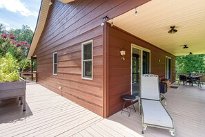 A wooden house with a covered porch, a small table with chairs, and a bird feeder. - Serene Wooded Cabin w/ Decks, 4 Mi to Dtwn Murphy (Murphy)