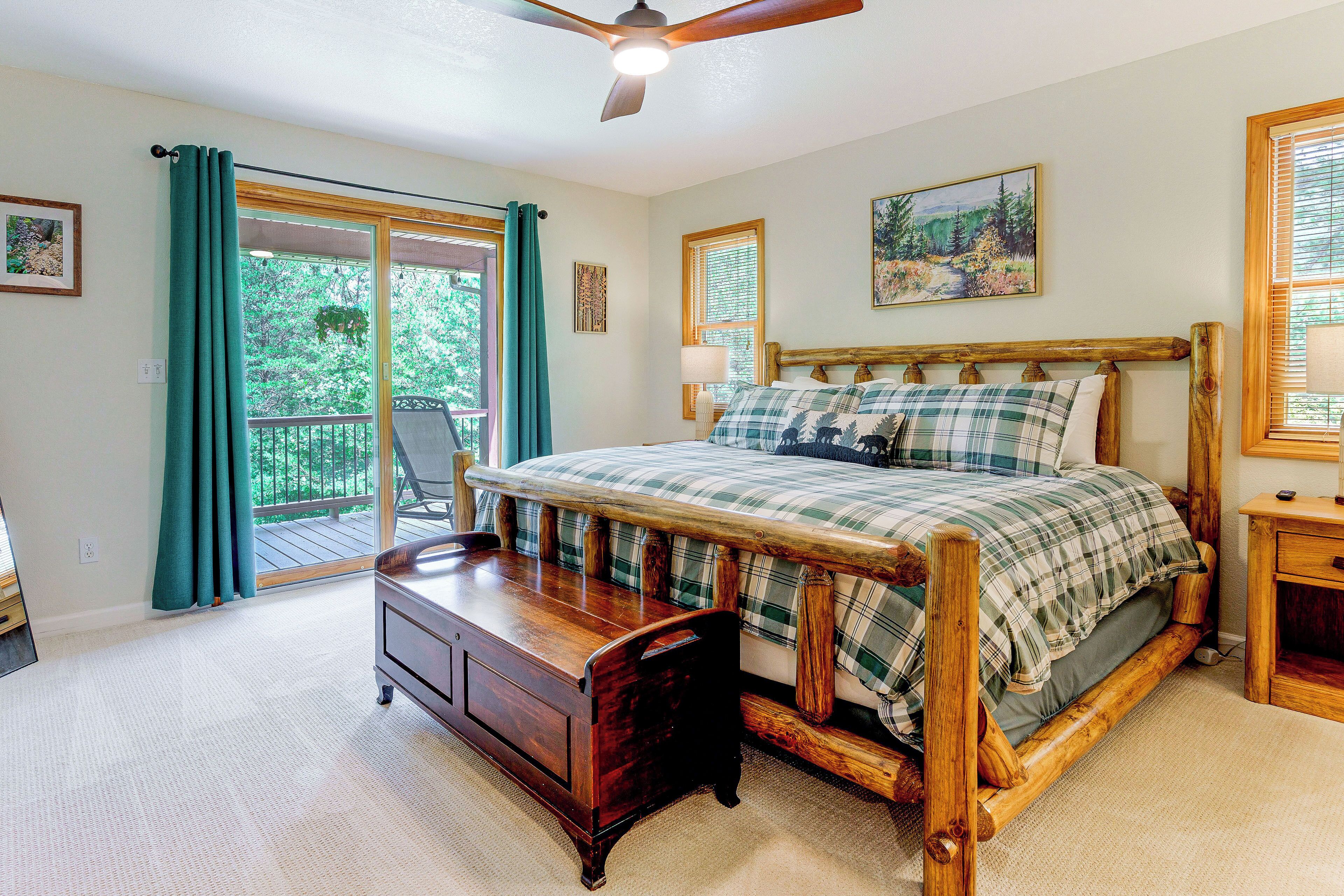 A bedroom with a wooden bed, a dresser, a chair, and a balcony with curtains.