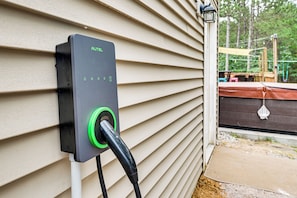 An outdoor electrical outlet with a green plug connected to a black cord. - 'rome-in Retreat' at Petenwell Lake (Nekoosa)