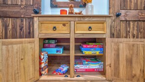 A wooden cabinet with two drawers and multiple board games. - Blue Ridge Views, Hot Tub! Murphy Mtn Cabin (Murphy)