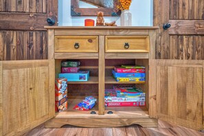A wooden cabinet with two drawers and multiple board games. - Blue Ridge Views, Hot Tub! Murphy Mtn Cabin (Murphy)