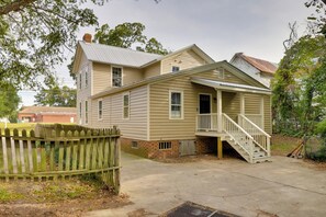 A two-story house with a front porch and a staircase leading to the second floor. - Walk to Downtown: Family Gem in Historic Edenton (Edenton)