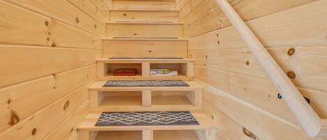 Un intérieur en bois avec un escalier menant à une mezzanine.