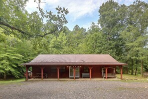 A wooden cabin with a porch, set in a forested area. - Great for Families! Wolf pen Gap ATV Base on Creek (Mena)