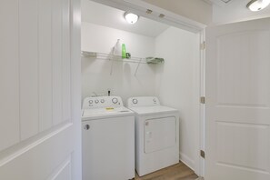 A laundry room with two white washing machines and a shelf above them. - Great for Groups! 2 Centrally Located Concord Gems (Concord)