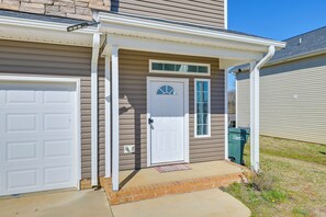 A residential house with a garage, a front door, and a small porch. - Great for Groups! 2 Centrally Located Concord Gems (Concord)