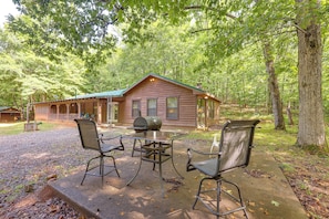 A cabin with a porch, a grill, and two chairs. - Wolf Pen Gap ATV Secluded Family Sanctuary (Mena)