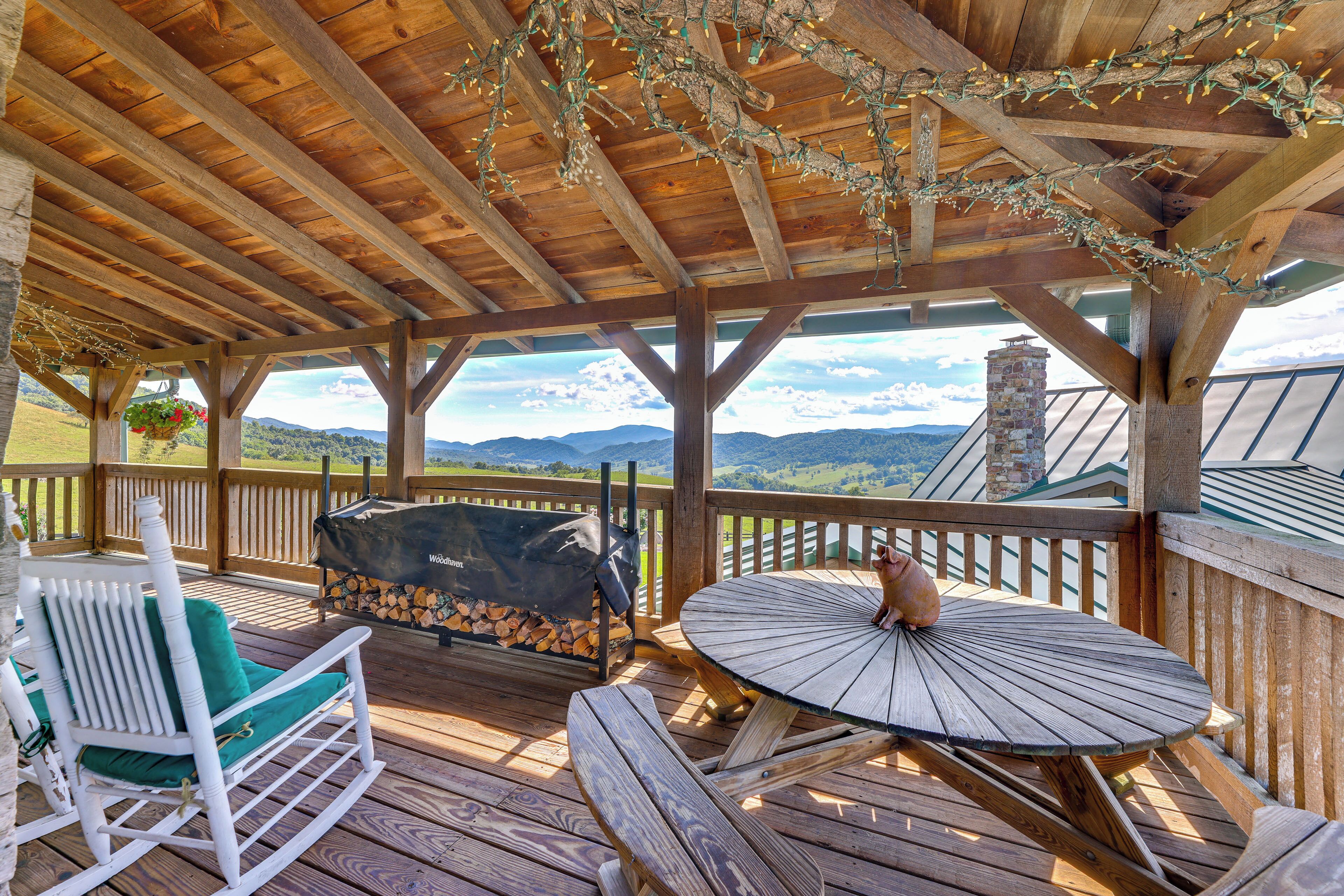 A covered outdoor seating area with a view of the landscape.