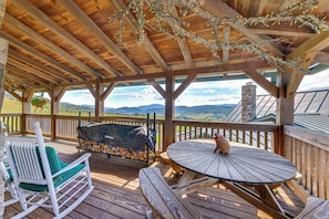 A covered outdoor seating area with a view of the landscape.