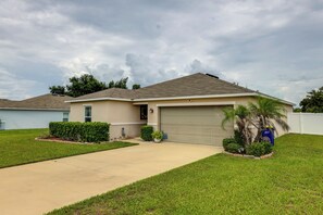 A single-story house with a garage, a front lawn, and a driveway.