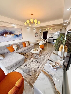 A modern living room with a sofa, coffee table, and decorative pillows.