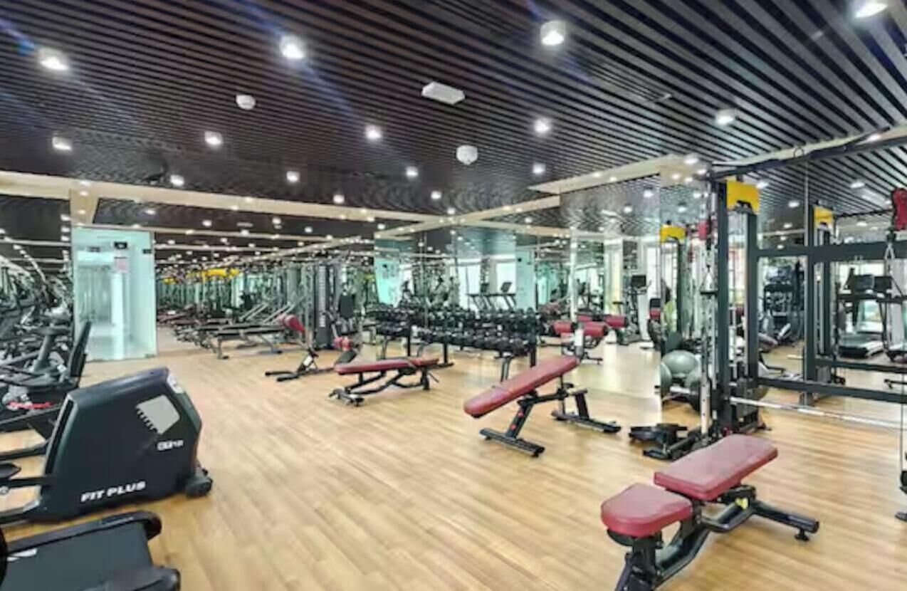 A gym with various exercise equipment, including treadmills and weight machines.