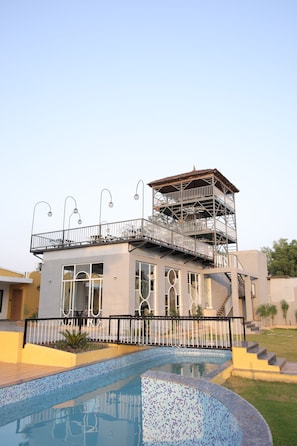 A two-story building with a swimming pool in front. - Sai Dhara Resort (Kasrawad)