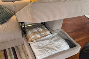 A convertible sofa with a storage compartment underneath.