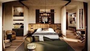 Een slaapkamer met een groot bed, een kledingkast, een kaptafel en een zithoek.