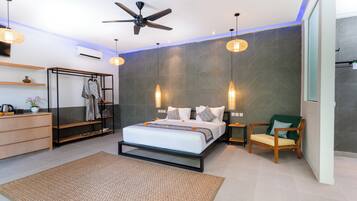A modern bedroom with a bed, a ceiling fan, a wardrobe, a chair, and a bedside table.