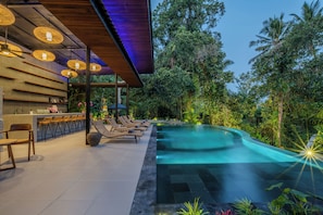 A modern outdoor pool area with lounge chairs and a bar. - Lula Boutique by The Studios Ubud (Ubud)