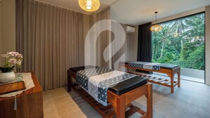 A room with a bed, a desk, a chair, a hanging light fixture, and a view of greenery outside. - Lula Boutique by The Studios Ubud  (Ubud)