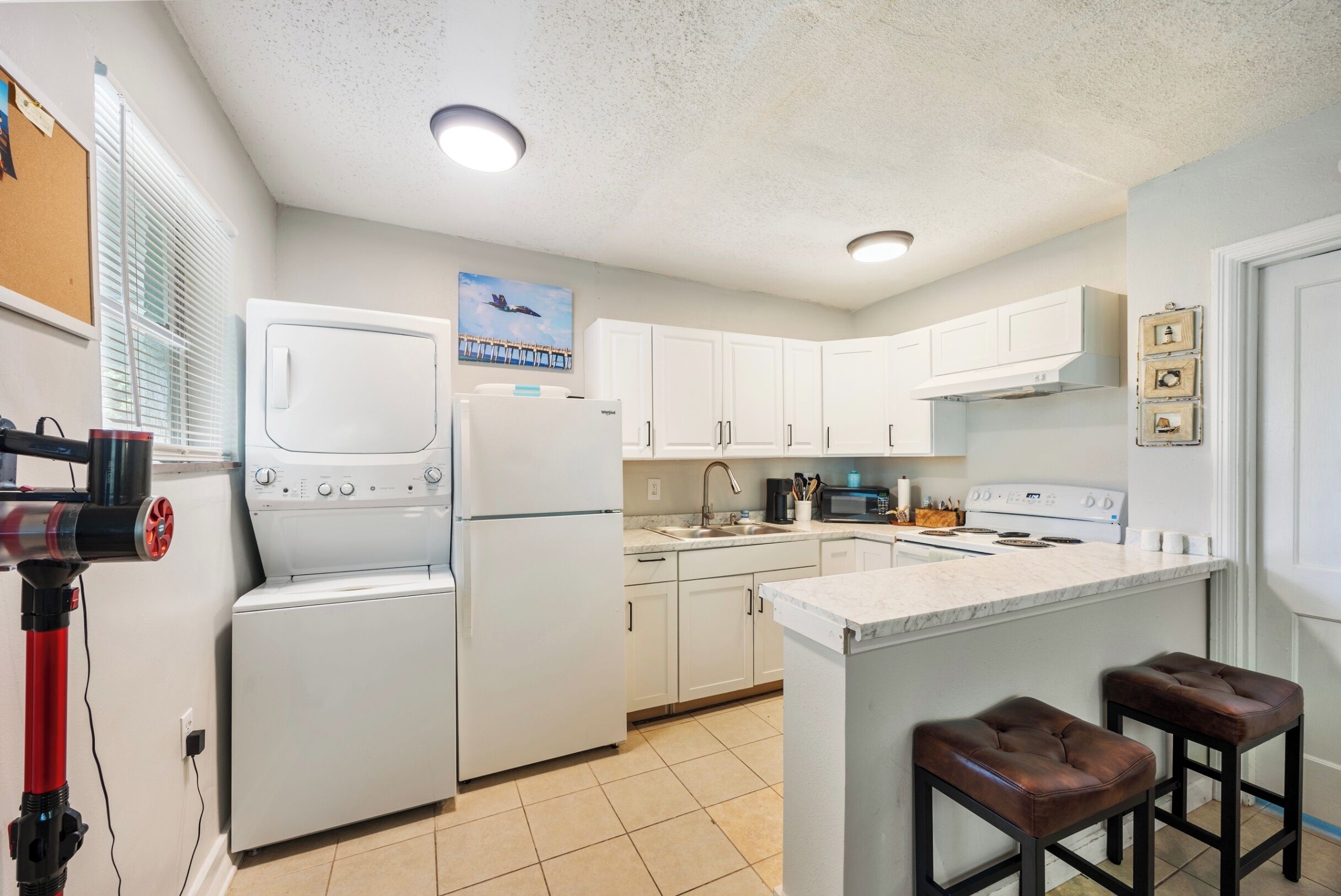 Coffee/tea maker, fridge, oven, dining table