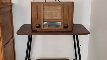 A wooden radio on a table with a globe above it.