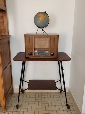 Una radio de madera sobre una mesa, con un globo encima.