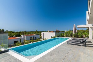 A rooftop pool with a clear view of the surrounding buildings and landscape. - Enjoy a relaxing stay at Villa Sea View Saleda, a modern four-bedroom villa for up to nine guests with a private pool, jacuzzi, summer kitchen and panoramic views towards the sea. (Krnica)