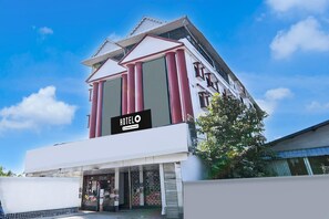A hotel with a modern facade, a prominent sign, and a storefront with visible signage. - Saver Double Utsho Hotel (Jalpaiguri)