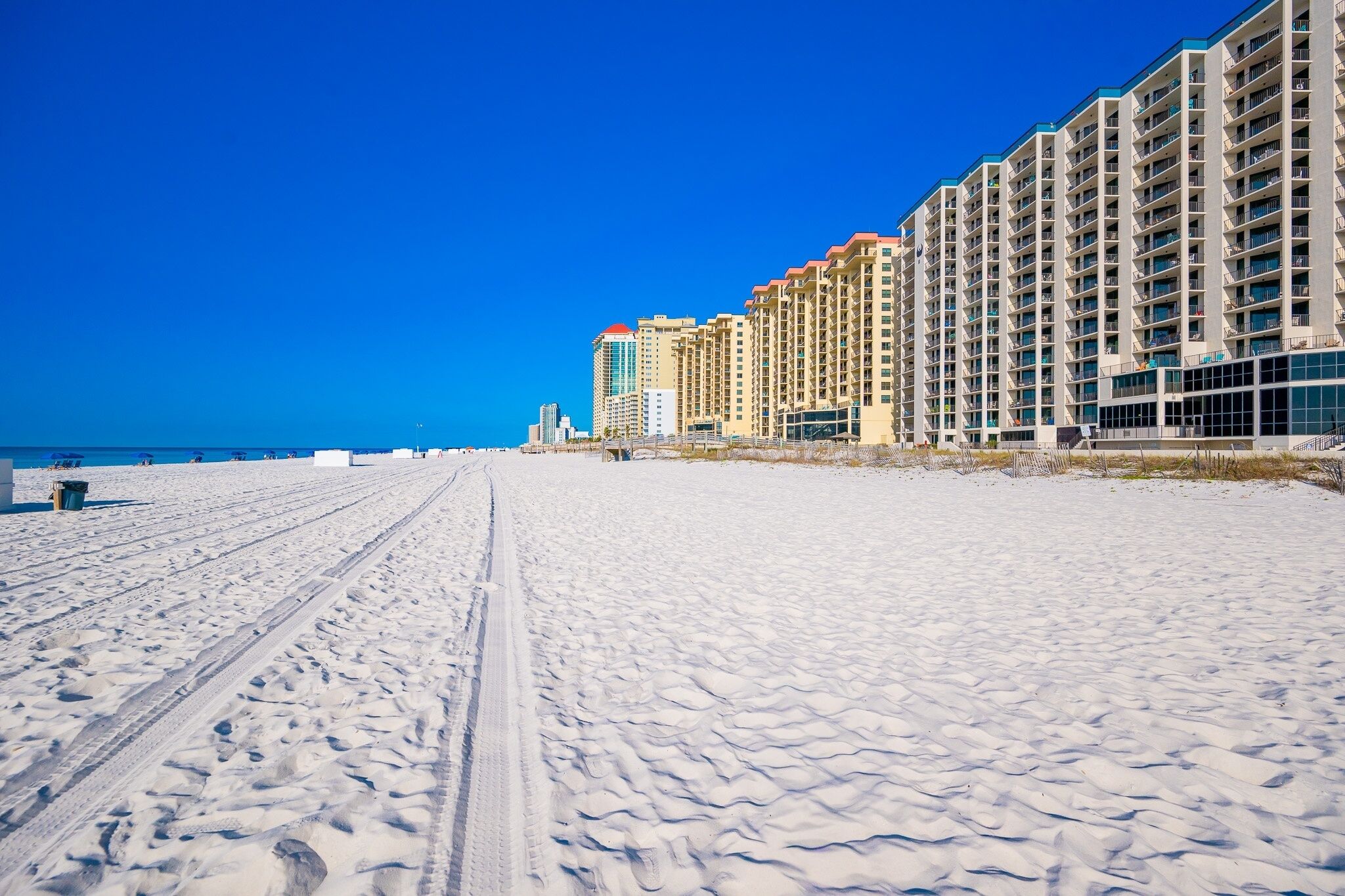 A snow-covered beach with a row of high-rise buildings.