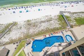 A resort with a large pool area, a beach with umbrellas, and a boardwalk. - Phoenix Iii 3098 2 Bedroom Condo (Orange Beach)