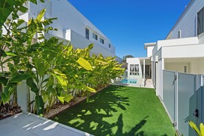 A modern residential building with a swimming pool, surrounded by lush greenery and a well-maintained lawn. - 17 Elluisa Close : 4  BR, 3  BA House in Forster, Sleeps 8 (Forster)