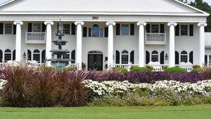 A large white building with columns, a fountain, and a number '380' on the facade. - 501l Studio (Calabash)