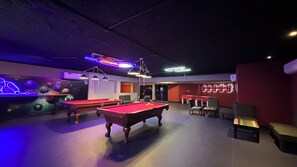 A pool hall with two pool tables, chairs, and a billiard table. -  XANADU CASA DE LA PLAYA (Puerto Plata)