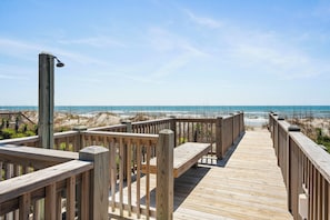 A wooden boardwalk leading to a beach with a clear sky. - Top-Floor Ocean Views | Pool + Beach Access (Emerald Isle)