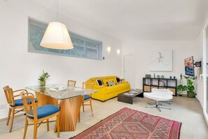 A modern living room with a yellow sofa, a glass dining table, and a coffee table. - [IndependentHouse] 5TERRE/ garden+parking+ A/C (La Spezia)