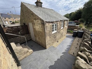 A stone building with a sloped roof, a small door, and a window. - 2 Bentley Bridge Cottages (Matlock)