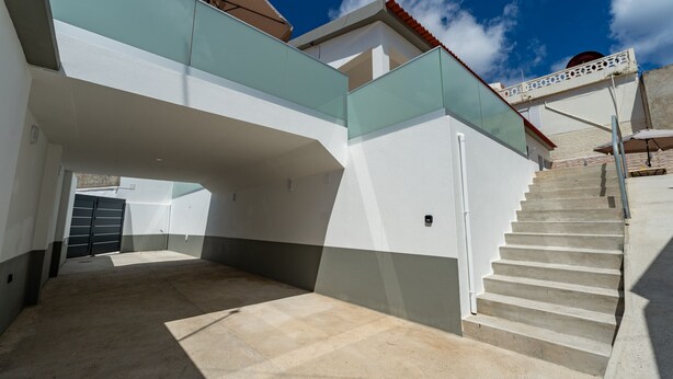 A modern building with a staircase leading to a second floor. - Casa Turalves - By WeHostMadeira (Porto Santo)