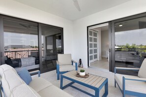 A modern balcony with a sofa, chairs, and a coffee table. - Brand new, walking distance to Sombrero Beach! 4 Bed/4.5 Bath outdoor kitchen. (Marathon)