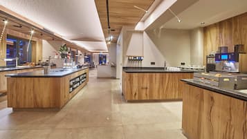 A modern kitchen with wooden cabinetry, a central island, and a coffee station.