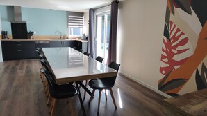 A modern kitchen with a dining area.
