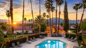 A swimming pool with lounge chairs and palm trees, surrounded by a landscaped garden and a building with a red roof. - 25% Off Sept 10-13 Perfect 4 Families Pool, Tennis (Palm Springs)