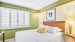 A hotel room with a bed, a bedside table, a lamp, a window with shutters, and a framed picture on the wall. - 25% Off Sept 10-13 Perfect 4 Families Pool, Tennis (Palm Springs)