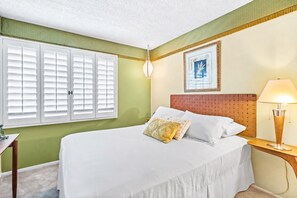 A hotel room with a bed, a bedside table, a lamp, a window with shutters, and a framed picture on the wall. - 25% Off Sept 10-13 Perfect 4 Families Pool, Tennis (Palm Springs)